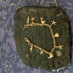 New, never worn, girls 6" gold charm bracelet with dangling sea creature charms